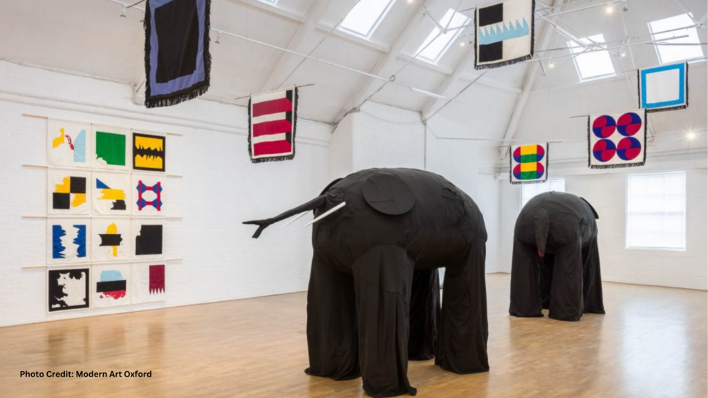 Interior of an exhibit room at Modern Art Oxford, featuring large elephant cloth sculptures on display.