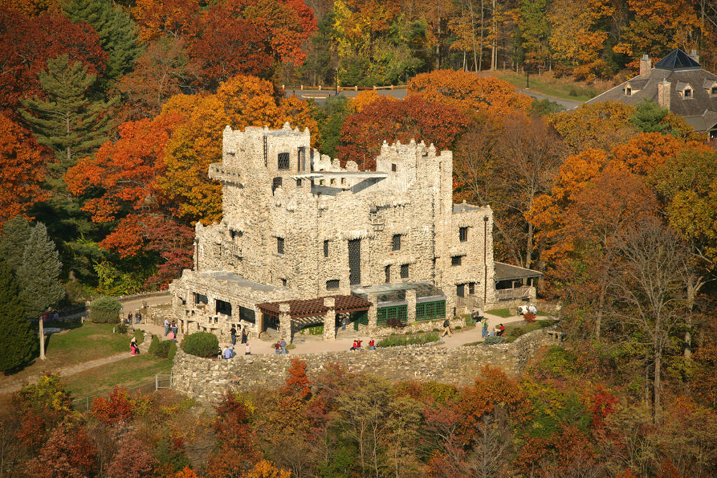 Gillette Castle in Connecticut surrounded by vibrant autumn foliage and colorful trees.